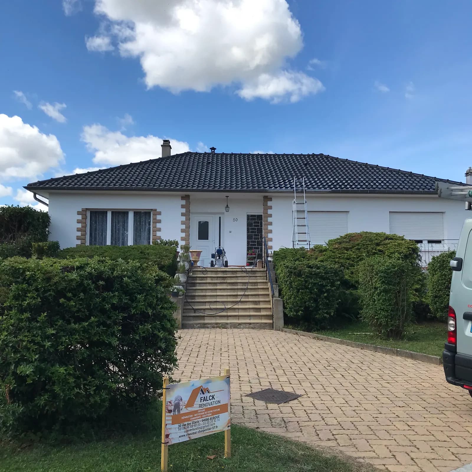 Pavillon à toiture en tuiles sombres, panneau Falck Rénovation dans l’allée